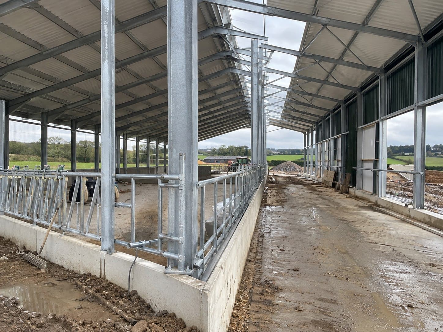 Long-span galvanized livestock barn frame under construction