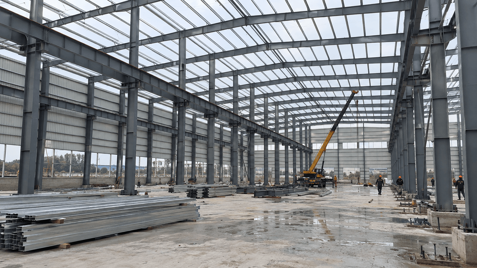 Steel workshop frame under construction with crane runway beams